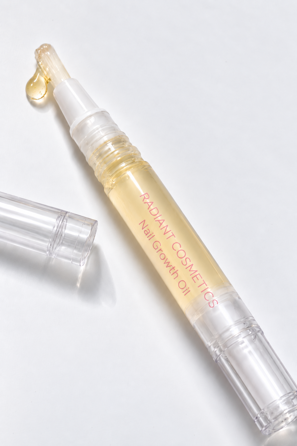 Radiant Cosmetics nail growth oil pen with a drop of oil