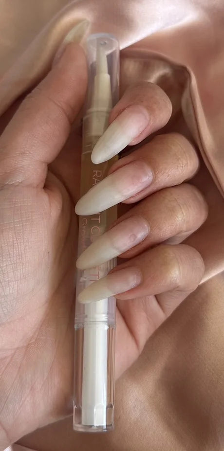 Nails after using Radiant nail growth oil: long natural nails holding the Radiant nail growth oil pen